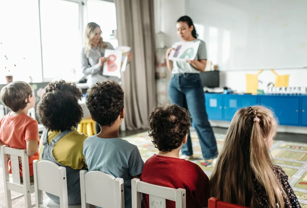 Teacher working with children during a classroom activity